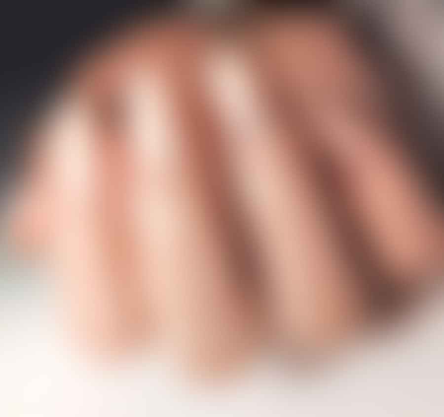 Close-up view of beautifully designed almond shaped toenails