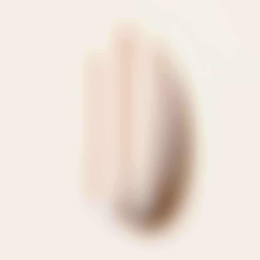 A thin brush drawing stripes on an almond shaped nail