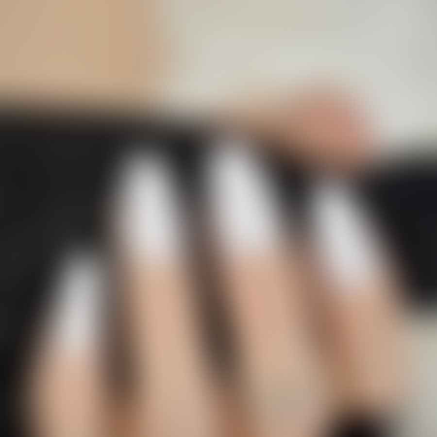 Elegant hand showcasing white matte almond-shaped nails