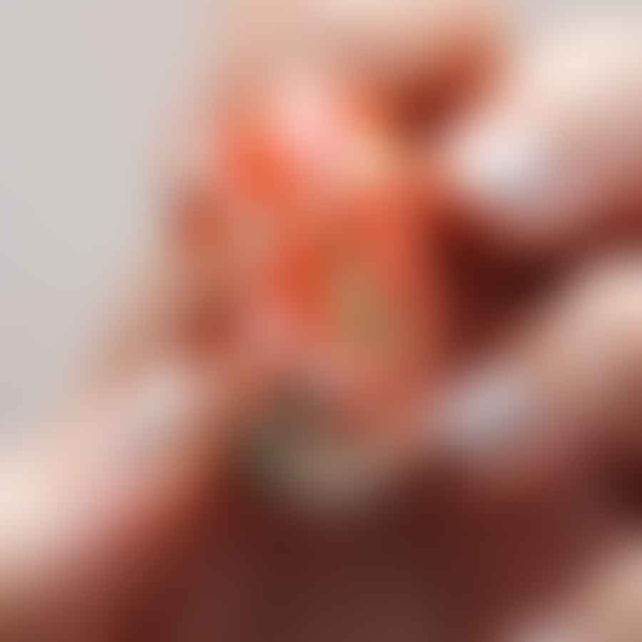 Hand painting an Easter design on almond-shaped nails