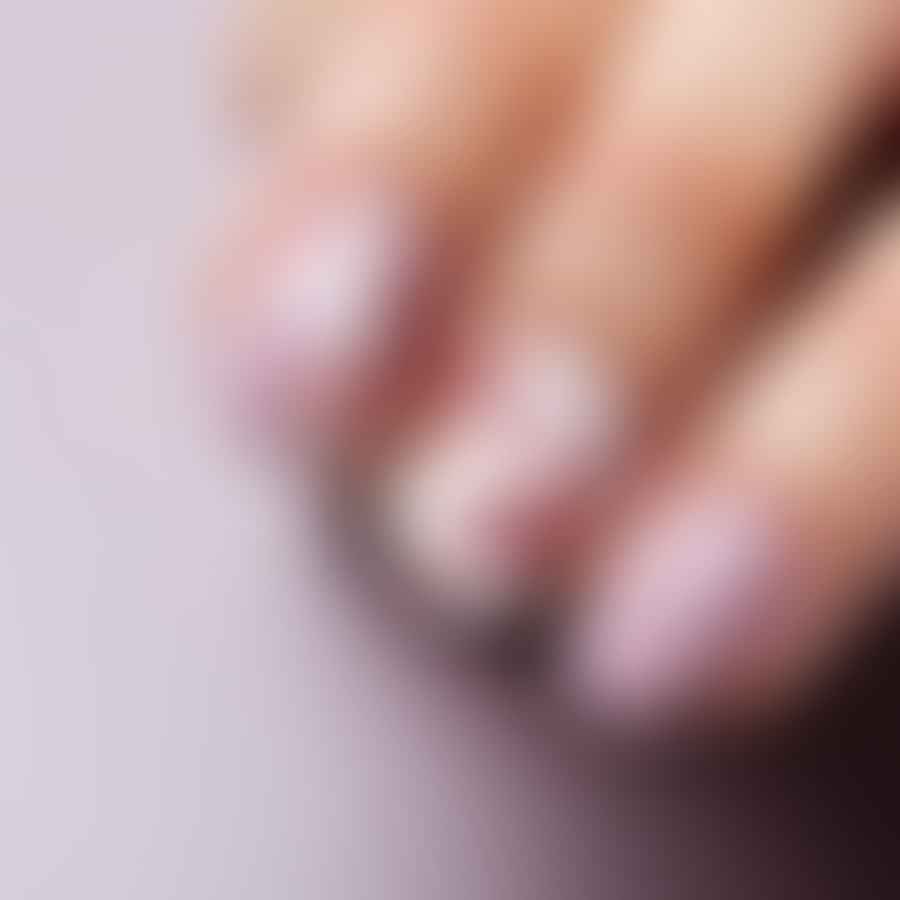 Applying top coat on short almond nails with nail art design
