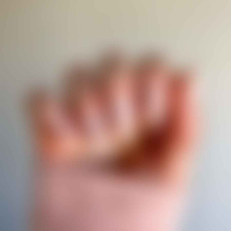 Close-up image of almond shaped nails with minimalistic designs