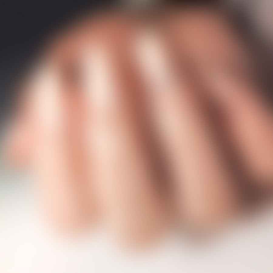 Step-by-step process of creating a simple nail design on almond shaped nails